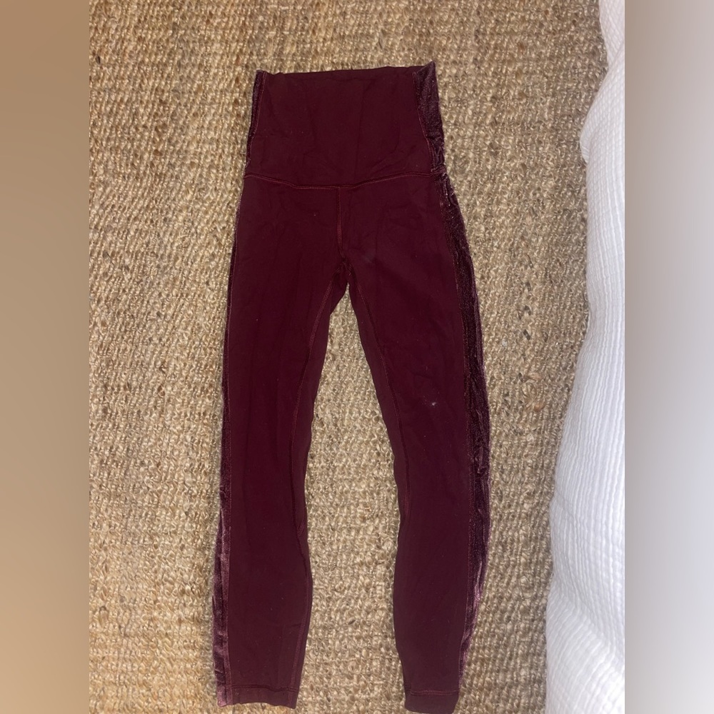 Lululemom leggings. Color maroon with pink felt lining down the sides. Size 4